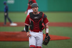 An IU Kokomo catcher walks back from the pitching mound.